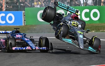 TOPSHOT - Mercedes' British driver Lewis Hamilton (R) collides with Alpine's Spanish driver Fernando Alonso (C) during the Belgian Formula One Grand Prix at Spa-Francophones racetrack at Spa, on August 28, 2022. (Photo by JOHN THYS / AFP) (Photo by JOHN THYS/AFP via Getty Images)