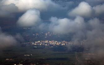 epa11060450 A general view shows the village of Gahjar, on the Israeli-Lebanon border, and the Lebanese village of Arab El Louaizeh in south Lebanon in the background, as seen from northern Israel, 06 January 2024. The Israeli military stated that the Israeli Air Force (IAF) struck terrorist targets in southern Lebanon following the sirens that sounded in northern Israel. Approximately 40 launches from Lebanon toward the area of Meron, in northern Israel, were identified. Tensions remain high in the region following the killing of senior Hamas leader Saleh al-Arouri in Lebanon by drone attack on 02 January.  EPA/ATEF SAFADI