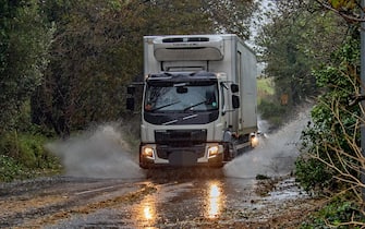 epa10954110 A lorry makes its way through heavy rain during Storm Ciaran in Dover, Kent, Britain, 02 November 2023.  The storm is causing severe disruption in the south of England with strong winds and rain. Flooding is expected in 54 areas, according to the Environment Agency, most of which are on the south coast of England.  EPA/Stuart Brock