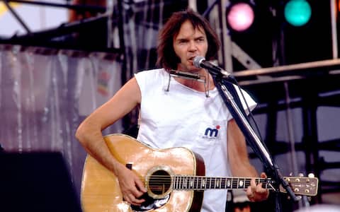 Neil Young at Live Aid at Veteren's Stadium in Philadelphia, Pennsylvania,  July 13, 1985 . (Photo by Paul Natkin/Getty Images)


