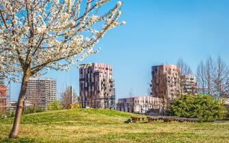 Bologna Quartiere Navile in Italy with Trilogia Navile modern building city park in spring .