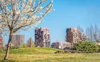 Bologna Quartiere Navile in Italy with Trilogia Navile modern building city park in spring .