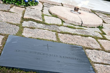 The flame burns at the gravesite of former US President John F. Kennedy at Arlington National Cemetery in Arlington, Virginia, on November 22, 2013, the 50th anniversary of his assassination.   With flags fluttering at half-staff, the United States paused Friday to mourn President John F. Kennedy and a generation's broken dreams, cut down 50 years ago by an assassin's bullet. AFP PHOTO/Nicholas KAMM        (Photo credit should read NICHOLAS KAMM/AFP via Getty Images)