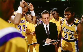 LOS ANGELES - 1989:  Head Coach Pat Riley of the Los Angeles Lakers draws up a play during a timeout for Magic Johnson #32 and Kareem Abdul Jabbar #33 during an NBA game circa 1989 at the Forum in Los Angeles, California.  NOTE TO USER: User expressly acknowledges and agrees that, by downloading and/or using this Photograph, user is consenting to the terms and conditions of the Getty Images License Agreement.  Mandatory Copyright Notice: Copyright 1989 NBAE (Photo by Andrew D. Bernstein/NBAE via Getty Images)