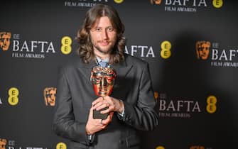 LONDON, ENGLAND - FEBRUARY 18:  Ludwig Göransson poses with the Original Score Award for 'Oppenheimer' in the winners room at the 2024 EE BAFTA Film Awards at The Royal Festival Hall on February 18, 2024 in London, England. (Photo by Samir Hussein/WireImage)