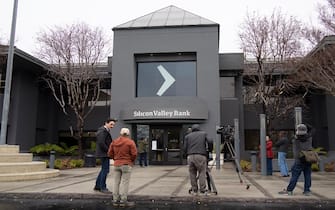 SANTA CLARA, CALIFORNIA - MARCH 10: Media staff report in front of the headquarters of Silicon Valley Bank on March 10, 2023 in Santa Clara, California. (Photo by Liu Guanguan/China News Service/VCG via Getty Images)