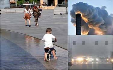 un bimbo in bici, una ciminiera e traffico nello smog