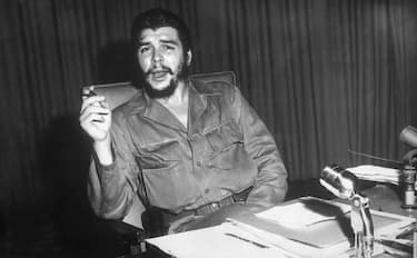 1960- Portrait of Ernesto "Che" Guevara, Cuban revolutionary leader, sitting at a desk.