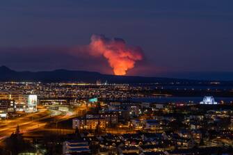 A volcano is spewing lava and smoke as it erupts in Reykjanes Peninsula, Iceland, on January 14, 2024. The volcanic eruption, which occurred in southwest Iceland on Sunday, presents an imminent danger to a neighboring fishing village, which had been previously evacuated due to concerns about a potential eruption, officials say. (Photo by Snorri Thor/NurPhoto via Getty Images)