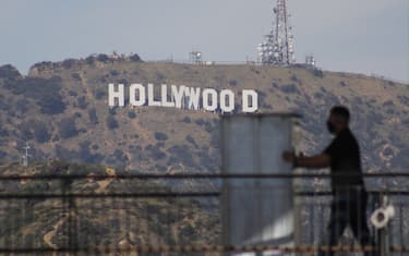 A worker moves equipment past the Hollywood Sign in preparation for the 94th Academy Awards in Hollywood, CA on Saturday, ​March 26, 2022. (Photo By Conor Duffy/Sipa USA)