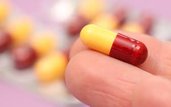 Amoxicillin antibiotic tablet capsule in a hand