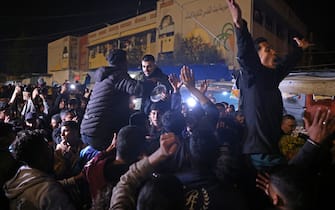 People celebrate along a street in Khan Yunis in the southern Gaza Strip on January 15, 2025, amid the ongoing war in the Palestinian territory between Israel and Hamas. Thousands of Gazans celebrated on January 15 as news spread that a ceasefire and hostage release deal had been reached between Israel and Hamas, aimed at ending more than 15 months of war in the Palestinian territory. (Photo by BASHAR TALEB / AFP)