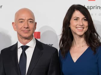Amazon CEO Jeff Bezos and his wife MacKenzie Bezos  poses as they arrive at the headquarters of publisher Axel-Springer where he will receive the Axel Springer Award 2018 on April 24, 2018 in Berlin. (Photo by JORG CARSTENSEN / dpa / AFP) / Germany OUT (Photo by JORG CARSTENSEN/dpa/AFP via Getty Images)