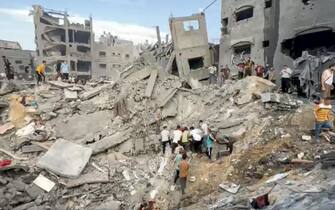 GAZA CITY, GAZA - OCTOBER 31: A screen grab captured from a video shared online shows people conducting search and rescue operation under the debris of a destroyed building as Israeli airstrike continue on the 25th day at Jabalia refugee camp in Gaza City, Gaza on October 31, 2023. (Photo by Fadi Alwhidi/Anadolu via Getty Images)