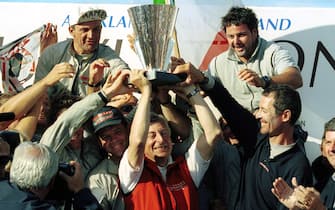 AKL13 - 20000206 - AUCKLAND, NEW ZEALAND : Pertrizio Bertelli ("Mr Prada" C-in red jacket) holds aloft the Louis Vuitton Cup with the help of the "Luna Rossa" crew at the cup presentation after Prada's win over "AmericaOne" on race day nine of the Louis Vuitton Cup finals in Auckland, New Zealand, 06 February 2000.  Prada won the start by one second and maintained their lead throughout the match, finishing 49 seconds ahead of AmericaOne and will go on to challenge for the America's Cup against Team New Zealand starting on the 19th of February. 
EPA PHOTO/AFP/PHOTOSPORT/BRUCE JARVIS/tm/re



