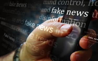 Social media on display with fake news and hoax information. Searching on tablet, pad, phone or smartphone screen in hand. Abstract concept of news titles broadcasting 3d illustration.
