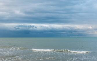 Sea water with waves and cloudy sky during a bad weather day