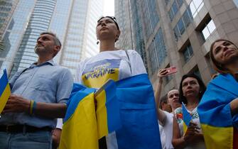 epa10487297 Ukraine supporters carry Ukraine flags during a peaceful demonstration to mark the first anniversary of the Russian invasion of Ukraine, in Bangkok, Thailand, 24 February 2023. Ukrainians and foreigners living in Bangkok gathered to support and solidarity for Ukrainian civilians on the first anniversary of Russian troop's invasion of Ukraine on 24 February 2022.  EPA/NARONG SANGNAK