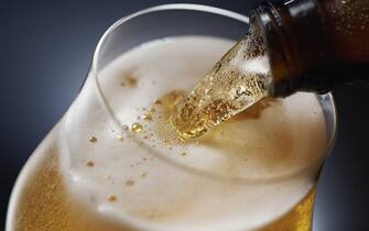 Beer being poured against a dark background