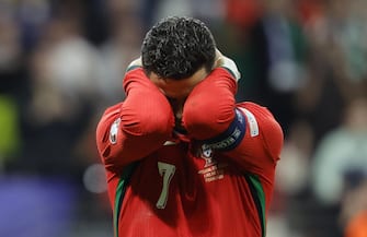 epa11451282 Cristiano Ronaldo of Portugal reacts after failing to score from the penalty spot during extra time of the UEFA EURO 2024 Round of 16 soccer match between Portugal and Slovenia, in Frankfurt Main, Germany, 01 July 2024.  EPA/RONALD WITTEK