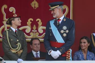 (FILES) (From L) Spanish Crown Princess of Asturias Leonor, Spain's King Felipe VI and Spain's Queen Letizia attend the Spanish National Day military parade in Madrid on October 12, 2023. Princess Leonor, the heiress to the Spanish crown, will swear loyalty to the constitution on October 31 on her 18th birthday, helping to turn the page on the scandal-tainted reign of her grandfather, Juan Carlos. After taking the oath Princess Leonor can legally succeed her father, King Felipe VI, and automatically becomes head of state in the event of the monarch's absence. (Photo by Pierre-Philippe MARCOU / AFP)