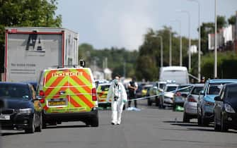 epa11506090 A police scenes of crime officer (SOCO) in Hart Street in Southport, Britain, 29 July 2024. Armed police detained a male and seized a knife after a number of people were injured in a reported stabbing according to Merseyside Police. Eight patients with stab injuries have been treated at the scene so far and have been taken to hospitals, North West Ambulance Service said.  EPA/ADAM VAUGHAN