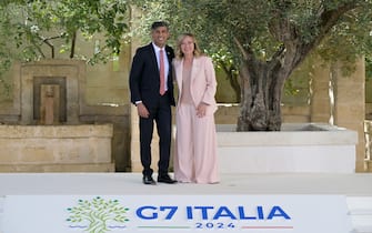 British Prime Minister Rishi Sunak is welcomed by Italy's Prime Minister Giorgia Meloni upon arrival at the Borgo Egnazia resort for the G7 Summit hosted by Italy in Apulia region, on June 13, 2024 in Savelletri. Leaders of the G7 wealthy nations gather in southern Italy this week against the backdrop of global and political turmoil, with boosting support for Ukraine top of the agenda. (Photo by Tiziana FABI / AFP)