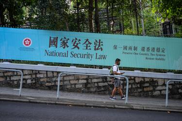HONG KONG, CHINA - JUNE 30: Pedestrians walks past a government-sponsored advertisement promoting a new national security law on June 30, 2020 in Hong Kong, China. (Photo by Billy H.C. Kwok/Getty Images)