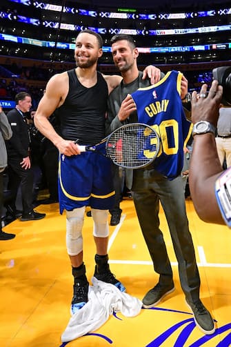 LOS ANGELES, CA - MACH 16: Stephen Curry #30 of the Golden State Warriors greets Novak Djokovic after the game against the Los Angeles Lakers on March 16, 2024 at Crypto.Com Arena in Los Angeles, California. NOTE TO USER: User expressly acknowledges and agrees that, by downloading and/or using this Photograph, user is consenting to the terms and conditions of the Getty Images License Agreement. Mandatory Copyright Notice: Copyright 2024 NBAE (Photo by Adam Pantozzi/NBAE via Getty Images)