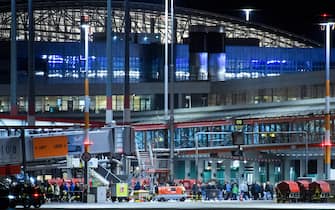 HAMBURG, GERMANY - NOVEMBER 05: Passengers are evacuated from Hamburg Airport on November 5, 2023 in Hamburg, Germany. According to media reports, a man armed with a gun drove a car through a perimeter gate onto the tarmac, where he attempted to set several fires. He reportedly also has two children in the car with him and is now in a standoff with police. All flights from the airport have been cancelled and approaching flights diverted. (Photo by Gregor Fischer/Getty Images)