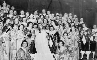 (Original Caption) New York born soprano Maria Meneghini-Callas bids goodbye to the applauding cast of Lucia Di Lammermoor after the final curtain call of her engagement at Chiacago's Civic Opera House. Acclaimed abroad, where she studied and married Baptist Meneghine, of Verona, Italy, Callas' Chicago engagement marked her U.S. debut. The versatile singer, who was cheered enthusiastically by Chicago audiences, is scheduled to open Milan's La Scala season December 7th in Spontini's La Vestale.