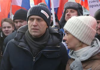 MOSCOW, RUSSIA - FEBRUARY 25:  (RUSSIA OUT) Russian opposition leader Alexei Navalny  (L) listens to his wife Yulia Navalnaya (R) during the Nemtsov March, a rally in memory of Boris Nemstov, former First Deputy Prime Minister, writer and opposition activist, killed 3 years ago at the bridge near the Kremlin, in Moscow, Russia, February 25, 2018. Russian opposition held rallies in Moscow and many other towns, gathered thousands suporters, prior to the Presidential Elections 2018 planned on March,18. (Photo by Mikhail Svetlov/Getty Images)