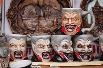 BRAN, ROMANIA - MARCH 10:  Mugs bearing a rendition of Dracula are displayed at a souvenir shop at Bran Castle, famous as "Dracula's Castle," on March 10, 2013 in Bran, Romania. Bran Castle's reputation as the supposed home to Dracula corresponds little with Bram Stoker's novel, nor did Vlad Tepes, the sadistic 15th-century Wallachian prince, ever live there. Nevetheless the castle retains the myth and tourists flock there in large numbers. Bran Castle, along with the mountainous region of southern Transylvania, which is home to Saxon fortified towns and churches, are among the asssets the Romanian government hopes will bring increasing numbers of tourists to the country. Both Romania and Bulgaria have been members of the European Union since 2007 and restrictions on their citizens' right to work within the EU are scheduled to end by the end of this year. However Germany's interior minister announced recently that he would veto the two countries' entry into the Schengen Agreement, which would not affect labour rights but would prevent passport-free travel.  (Photo by Sean Gallup/Getty Images)