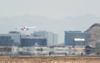 PHOENIX, ARIZONA - JULY 15: An airplane approaches the runway at the Phoenix Sky Harbor International Airport during a heat wave on July 15, 2023 in Phoenix, Arizona. Weather forecasts today are expecting temperatures to reach 115 degrees. The Phoenix area is grappling with record-breaking temperatures as prolonged heat waves continue soaring across the Southwest. (Photo by Brandon Bell/Getty Images)
