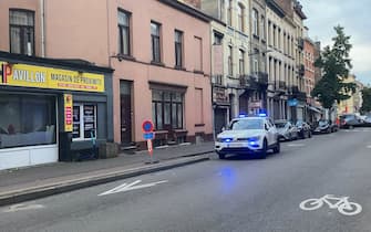 A police car drives near the Eugene Verboekhovenplein in the Schaerbeek area of Brussels on October 17, 2023, where the suspected perpetrator of the attack in Brussels was probably shot during a police intervention in a cafe. Belgian police on October 17, 2023 arrested a man suspected of having gunned down two Swedish football fans in an attack in Brussels, a spokesman for the federal prosecutors' service said. (Photo by LOU LAMPAERT / BELGA / AFP) / Belgium OUT (Photo by LOU LAMPAERT/BELGA/AFP via Getty Images)