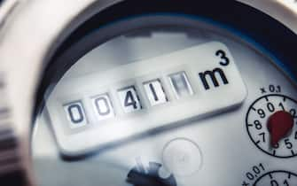 Close up of water meter with rotating digit.