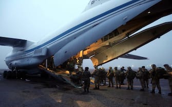 KANT, KYRGZSTAN - JANUARY 7: (---EDITORIAL USE ONLY â MANDATORY CREDIT - "KYRGZSTAN DEFENCE MINISTRY / HANDOUT" - NO MARKETING NO ADVERTISING CAMPAIGNS - DISTRIBUTED AS A SERVICE TO CLIENTS----) Kyrgyz military vehicles are being loaded onto a Russian military plane Ilyushin IL76, at the airbase in Kyrgyzstan's Kant city on 07 January 2022. 150 soldiers, 8 armored vehicles and 11 vehicles carrying supplies were sent to Kazakhstan. (Photo by Kyrgyzstan Defence Ministry / Handout/Anadolu Agency via Getty Images)