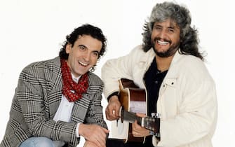 "Actor and movie director Massimo Troisi and his friend Pino Daniele, a very successful musician and singer, pose together smiling; Daniele has worked with Troisi creating the soundtrack of three of his movies, the last of which, ""I Thought It Was Love"", is in cinemas on 1991 in Italy.  (Photo by Rino Petrosino\Mondadori via Getty Images)"