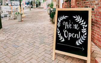 Close-up of store open signage in downtown district