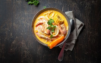 zuppe Peruvian seafood soup Chupe de Camarones in gray bowl, top view.