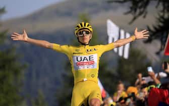 epa11489396 Yellow jersey Slovenian rider Tadej Pogacar of UAE Team Emirates celebrates as he crosses the finish line and winning the 20th stage of the 2024 Tour de France cycling race over 132km from Nice to Col de la Couillole, France, 20 July 2024.  EPA/GUILLAUME HORCAJUELO