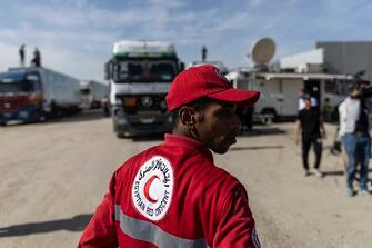 NORTH SINAI, EGYPT - OCTOBER 21: A man from the Egyptian Red Crescent looks on as aid convoy trucks make their way to cross the Rafah border from the Egyptian side on October 21, 2023 in North Sinai, Egypt.  The aid convoy, organized by a group of Egyptian NGOs, set off Saturday 14th October from Cairo for the Gaza-Egypt border crossing at Rafah. A week of tortuous negotiations followed about when the border, controlled by Egypt on one side and Hamas on the other, would be opened, until the first trucks were admitted on 21st October.  On October 7th, the Palestinian militant group Hamas launched a surprise attack on border communities in southern Israel, spurring the most violent flare-up of the Israel-Palestine conflict in decades. Israel launched a vast bombing campaign in retaliation and has warned of an imminent ground invasion.(Photo by Mahmoud Khaled/Getty Images)
