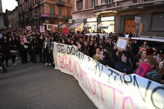 Activists of 'Non Una Di Meno' (not one less) feminist organisation protest with placards on occasion of the International Day for the Elimination of Violence Against Women, in Turin, Italy, 25 November 2023. The banner reads 'if I don't come back tomorrow you  burn everything.'  ANSA/ALESSANDRO DI MARCO