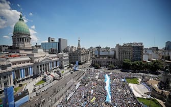 Supporters of Argentina's President-elect Javier Milei gather outside the Congress during the inauguration ceremony of Argentina's President-elect Javier Milei, in Buenos Aires on December 10, 2023. Libertarian economist Javier Milei was sworn in Sunday as Argentina's president, after a resounding election victory fueled by fury over the country's economic crisis. "I swear to God and country... to carry out with loyalty and patriotism the position of President of the Argentine Nation," he said as he took the oath of office, before outgoing President Alberto Fernandez placed the presidental sash over his shoulders. (Photo by Alejandro PAGNI / AFP)