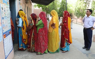 epa11288526 People queue at a polling station to cast their votes in the first phase of the general elections in Kotputli village in Rajasthan, India, 19 April 2024. Voting has begun in the Indian general elections. The elections will be held over seven phases between 19 April and 01 June 2024 with the results being announced on 04 June.  EPA/RAJAT GUPTA