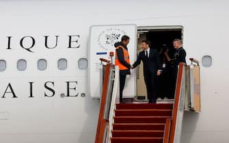 French President Emmanuel Macron (2nd L) disembarks his presidential plane at Beijing Capital International Airport in Beijing on April 5, 2023. (Photo by Ludovic MARIN / AFP) (Photo by LUDOVIC MARIN/AFP via Getty Images)