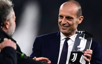 Juventus Italian coach Massimiliano Allegri receives the award for his 405th presence on the bench for Juventus before the Italian Serie A football match Juventus vs Udinese on February 12, 2024 at the “Allianz Stadium” in Turin. (Photo by MARCO BERTORELLO / AFP)
