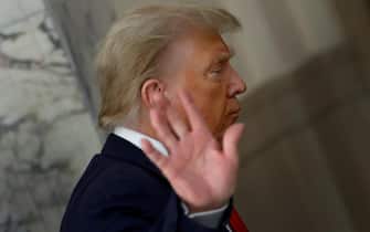 epa10900138 Former US President Donald J. Trump gestures to the media during a short recess on the third day of his civil fraud trial in New York, New York, USA, 04 October 2023. Trump, his adult sons and the Trump family business are facing a lawsuit by the State of New York accusing them of inflating the value of assets to get favorable loans from banks.  EPA/PETER FOLEY