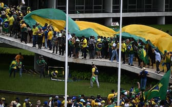 epa10396227 Bolsonaro supporters storm the National Congress in Brasilia, Brazil, 08 January 2023. Hundreds of supporters of former Brazilian President Jair Bolsonaro invaded the headquarters of the National Congress, and also Supreme Court and the Planalto Palace, seat of the Presidency of the Republic, in a demonstration calling for a military intervention to overthrow President Luiz Inacio Lula da Silva. The crowd broke through the cordons of security forces and forced their way to the roof of the buildings of the Chamber of Deputies and the Senate, and some entered inside the legislative headquarters.  EPA/ANDRE BORGES