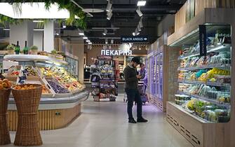 epa10298061 A man shops at a Miratorg supermarket in Moscow, Russia, 10 November 2022. Miratorg one of the leading agribusiness holdings and food retailers in Russia.  EPA/MAXIM SHIPENKOV